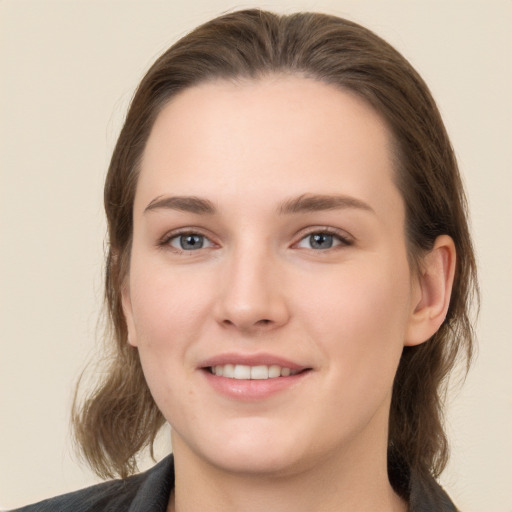 Joyful white young-adult female with long  brown hair and grey eyes