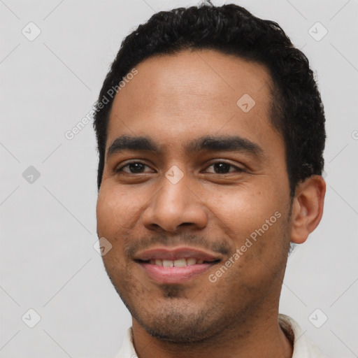 Joyful latino young-adult male with short  black hair and brown eyes