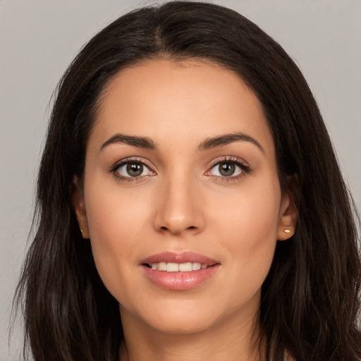 Joyful white young-adult female with long  brown hair and brown eyes