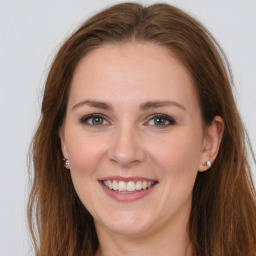 Joyful white young-adult female with long  brown hair and grey eyes