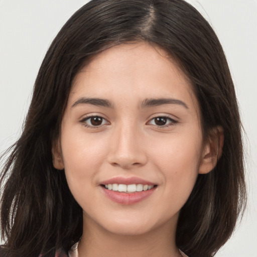 Joyful white young-adult female with long  brown hair and brown eyes