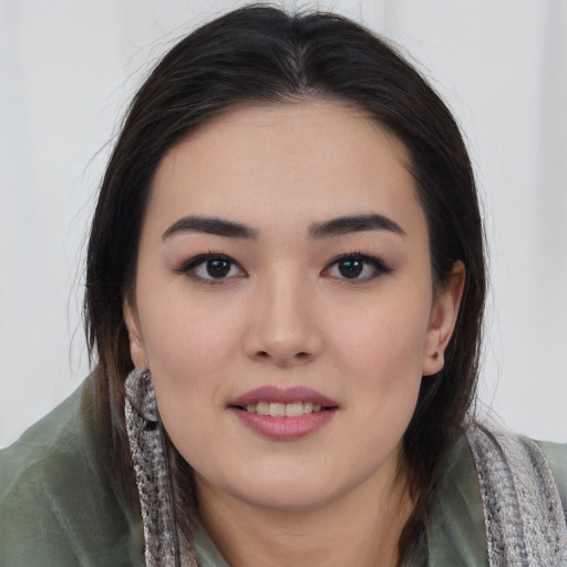 Joyful asian young-adult female with long  black hair and brown eyes