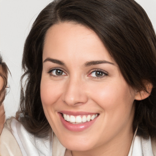 Joyful white young-adult female with medium  brown hair and brown eyes