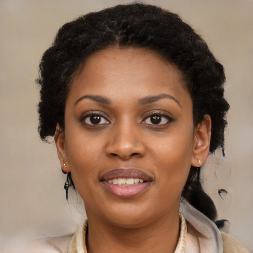 Joyful black young-adult female with long  black hair and brown eyes