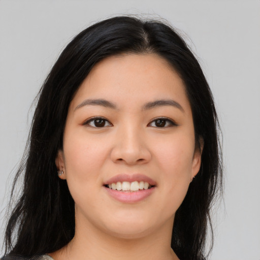 Joyful asian young-adult female with long  black hair and brown eyes