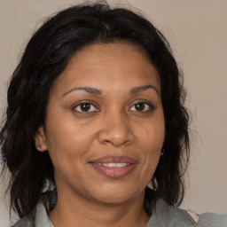 Joyful black adult female with medium  brown hair and brown eyes