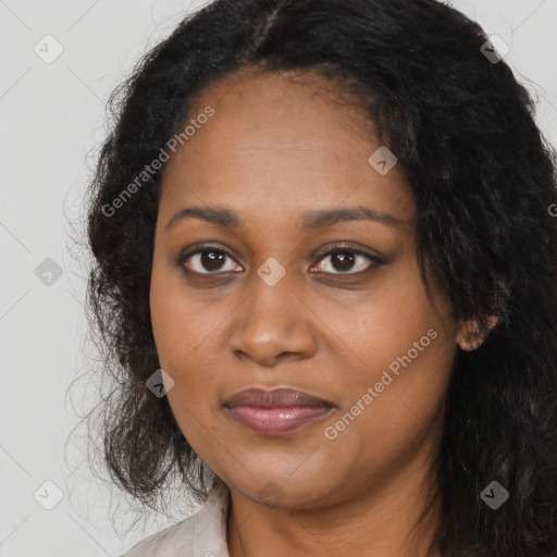 Joyful black young-adult female with long  black hair and brown eyes