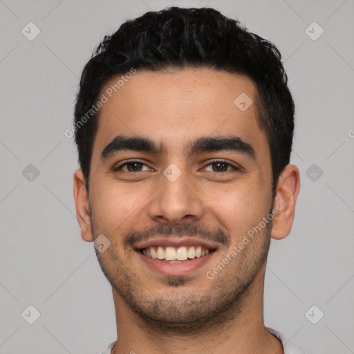 Joyful latino young-adult male with short  black hair and brown eyes