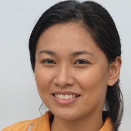 Joyful asian young-adult female with medium  brown hair and brown eyes