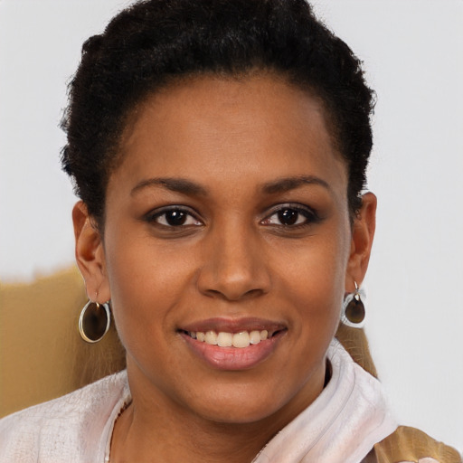 Joyful black young-adult female with short  brown hair and brown eyes