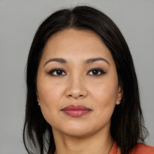 Joyful asian young-adult female with long  brown hair and brown eyes