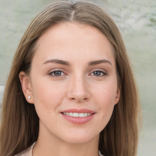 Joyful white young-adult female with long  brown hair and grey eyes