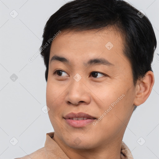 Joyful asian young-adult male with short  black hair and brown eyes