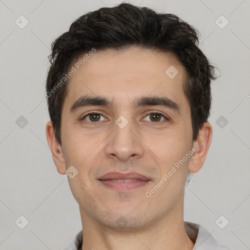 Joyful white young-adult male with short  black hair and brown eyes