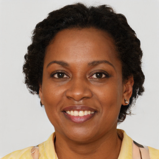 Joyful black adult female with short  brown hair and brown eyes
