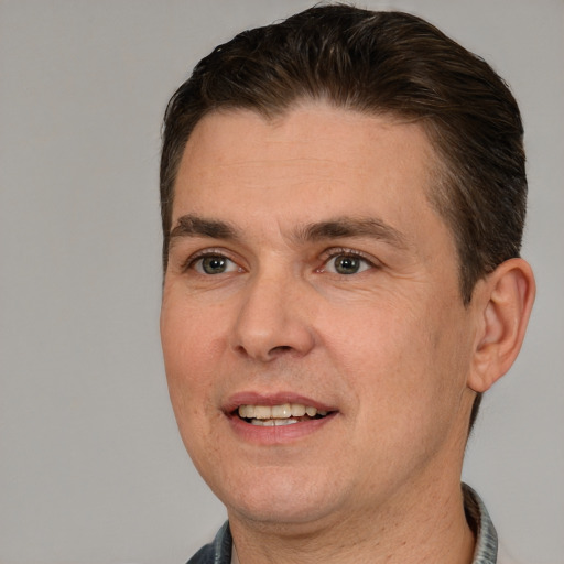 Joyful white adult male with short  brown hair and brown eyes