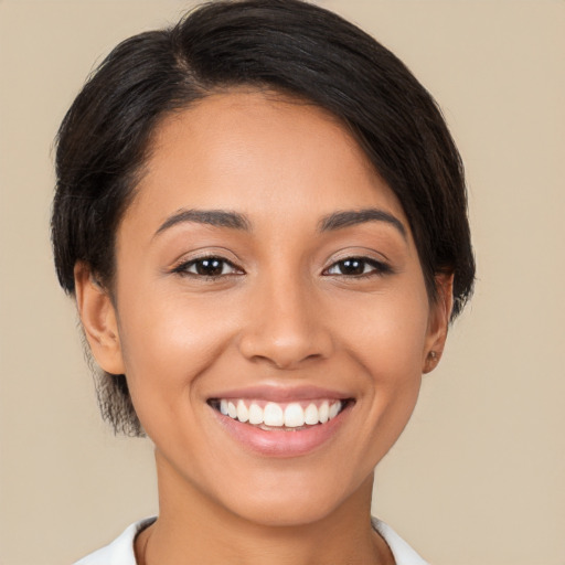 Joyful latino young-adult female with short  brown hair and brown eyes