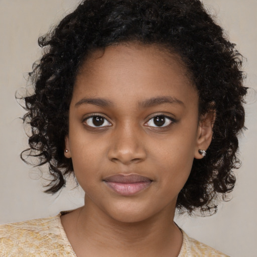 Joyful black child female with medium  brown hair and brown eyes