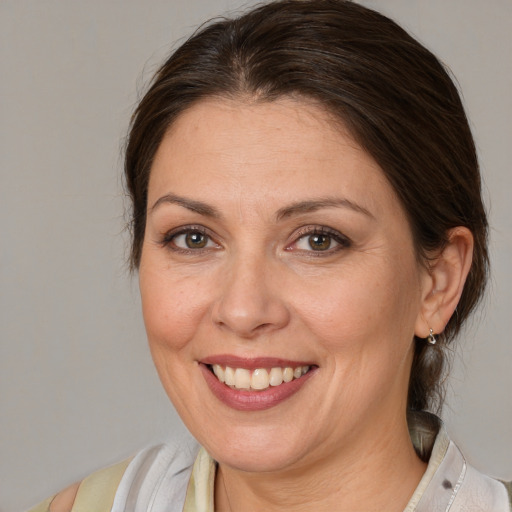 Joyful white adult female with medium  brown hair and brown eyes