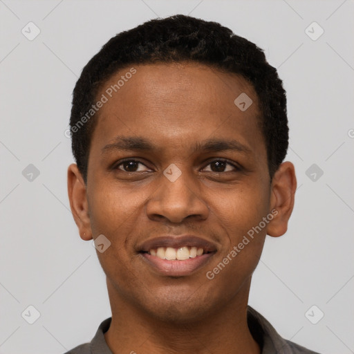 Joyful black young-adult male with short  black hair and brown eyes