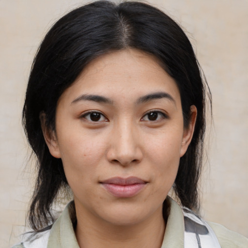 Joyful asian young-adult female with medium  black hair and brown eyes