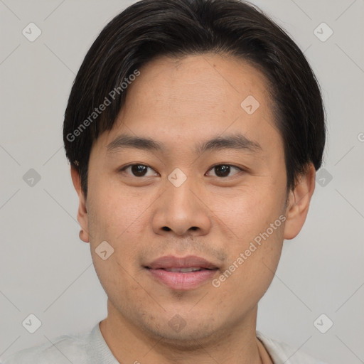 Joyful asian young-adult male with short  brown hair and brown eyes