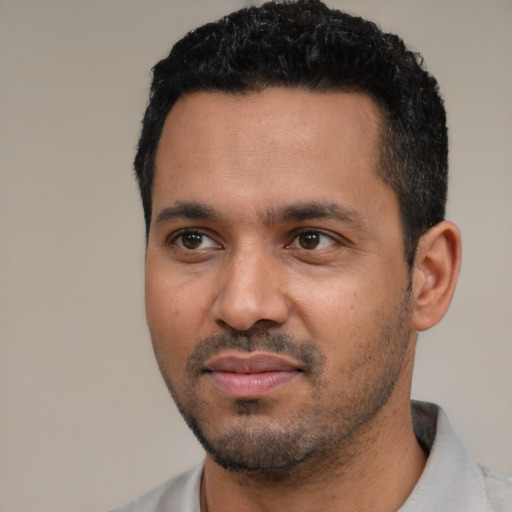 Neutral latino young-adult male with short  black hair and brown eyes