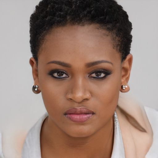 Joyful black young-adult female with short  brown hair and brown eyes