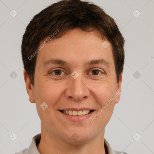 Joyful white adult male with short  brown hair and brown eyes