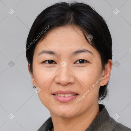 Joyful asian adult female with medium  black hair and brown eyes