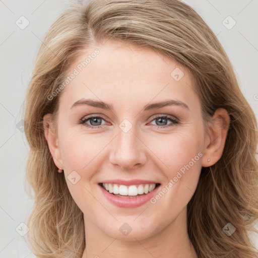 Joyful white young-adult female with long  brown hair and blue eyes