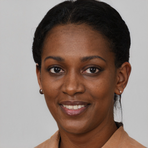 Joyful black young-adult female with short  black hair and brown eyes