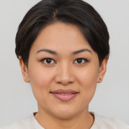 Joyful asian young-adult female with short  brown hair and brown eyes