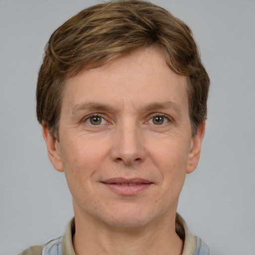 Joyful white adult male with short  brown hair and grey eyes