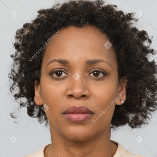 Joyful black adult female with short  brown hair and brown eyes