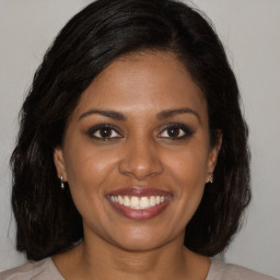 Joyful black young-adult female with medium  brown hair and brown eyes