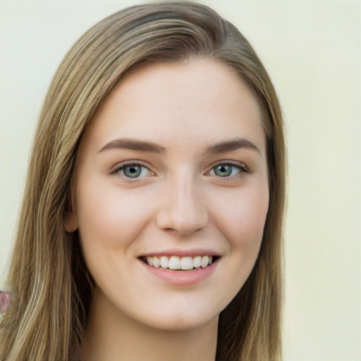 Joyful white young-adult female with long  brown hair and green eyes