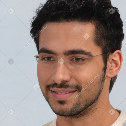 Joyful white young-adult male with short  black hair and brown eyes