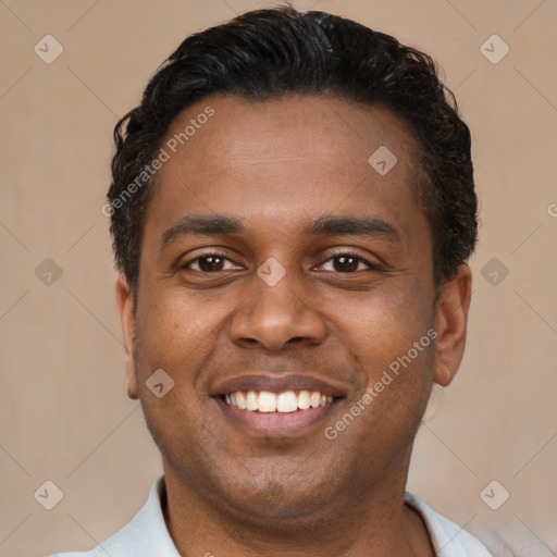 Joyful latino young-adult male with short  brown hair and brown eyes