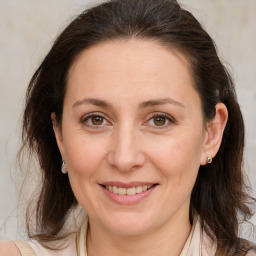 Joyful white adult female with medium  brown hair and brown eyes