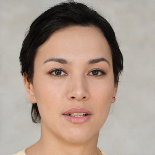 Joyful asian young-adult female with medium  black hair and brown eyes