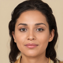 Joyful latino young-adult female with long  brown hair and brown eyes