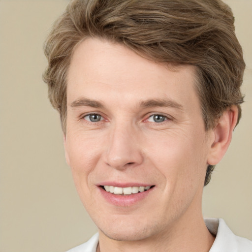 Joyful white adult male with short  brown hair and grey eyes