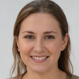 Joyful white young-adult female with long  brown hair and grey eyes