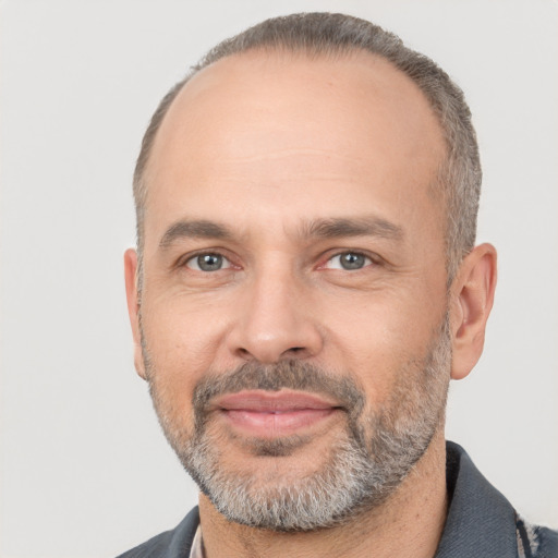 Joyful white adult male with short  black hair and brown eyes