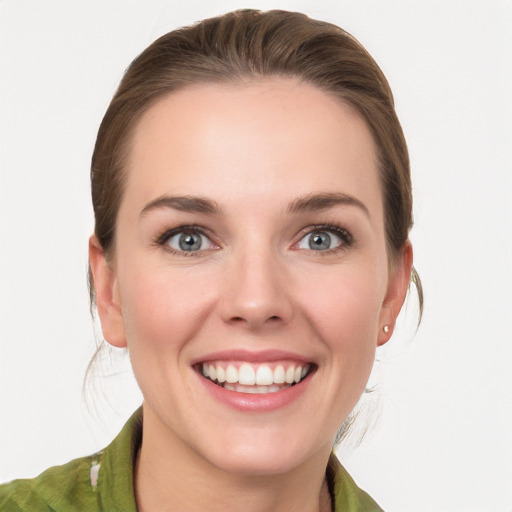 Joyful white young-adult female with medium  brown hair and grey eyes