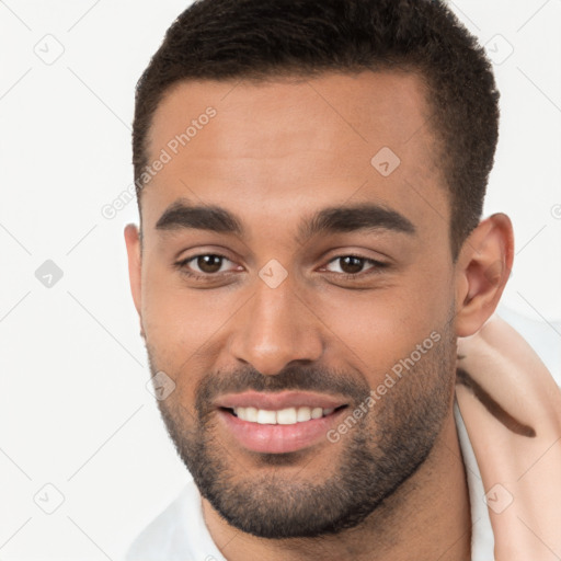 Joyful white young-adult male with short  brown hair and brown eyes