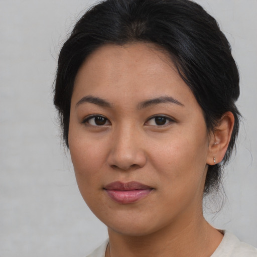 Joyful asian young-adult female with medium  brown hair and brown eyes