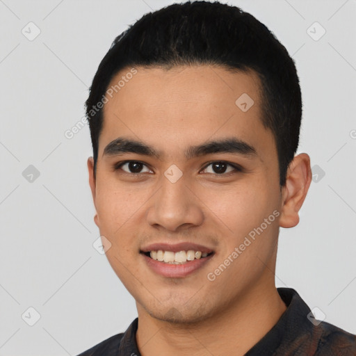 Joyful latino young-adult male with short  black hair and brown eyes