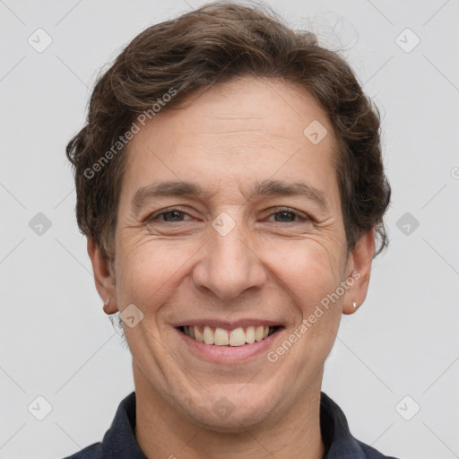 Joyful white adult male with short  brown hair and grey eyes